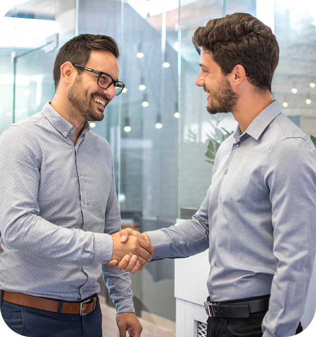image Two men shaking hands in office.